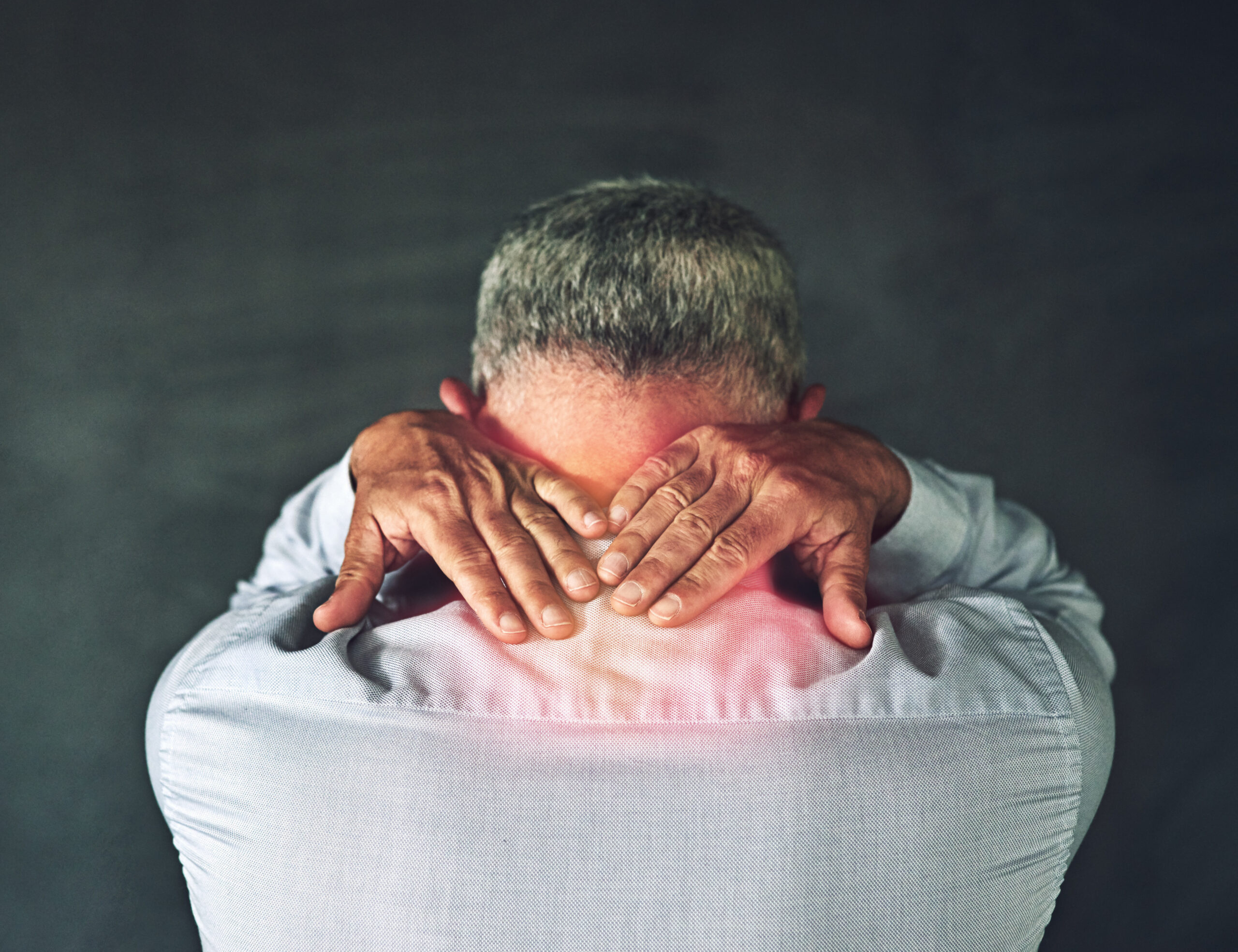 Stress, neck pain and back of businessman in studio with tension for burnout, medical crisis and red glow. Overlay, professional and person with muscle strain, accident and injury on gray background